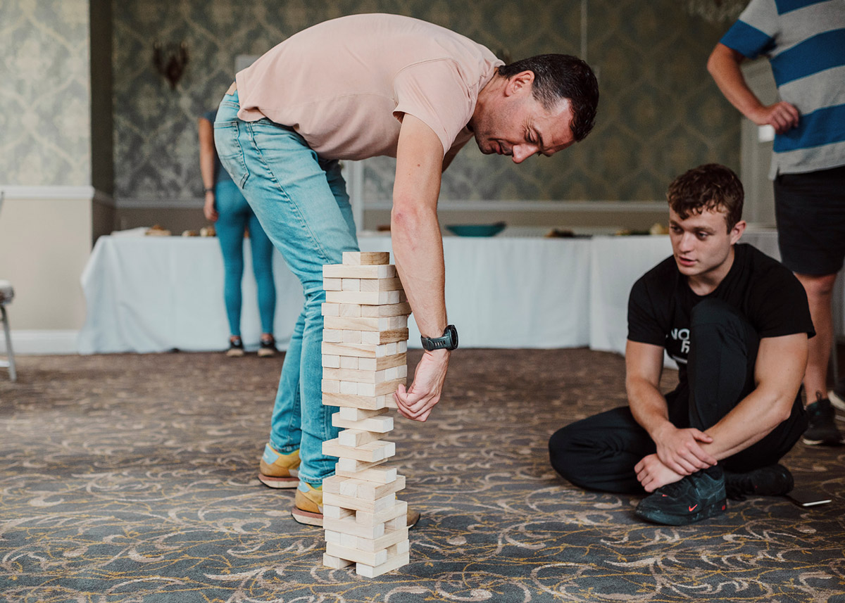 ground_and_water_teamday389_websize Man playing jenga